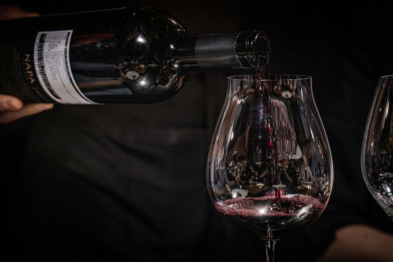 Red wine being poured from a bottle into a glass